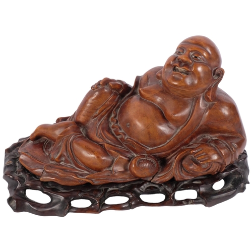 168 - A large carved hardwood reclining Buddha, on fitted stand, overall length 44cm