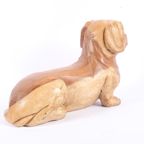 181 - A carved softwood study of a short legged dog, L36cm