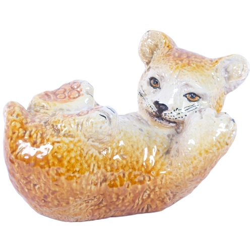 184 - A small Italian pottery playful lion cub, L22cm