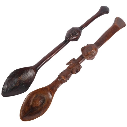 187 - 2 similar African Tribal wooden spoons, likely tourist pieces, larger spoon has fertility carving in... 