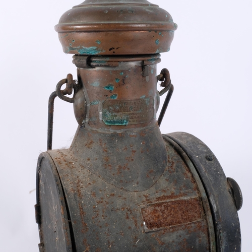 201 - A large early 20th century black painted metal and copper single blue lensed railway lantern, H45cm