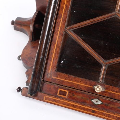 206 - A small 19th century burr-walnut hanging corner cabinet, glazed door, L51cm