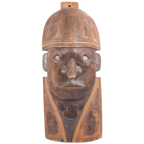 212 - A large South Seas hardwood wall plaque sculpture, with chip carved decoration and cowrie shell eyes... 