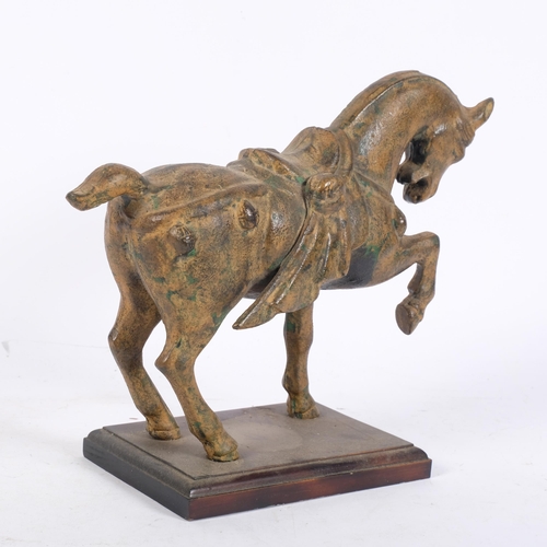 1019 - A patinated metal Tang style horse on stand, H24cm