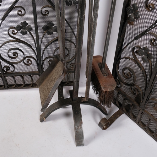 1029 - A 4-piece wrought-iron companion set on stand, H64cm, and pair of wrought-iron and mesh fire guards