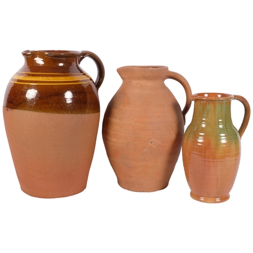 1032 - A half glazed Buckley terracotta jug, H36cm, and 2 smaller jugs