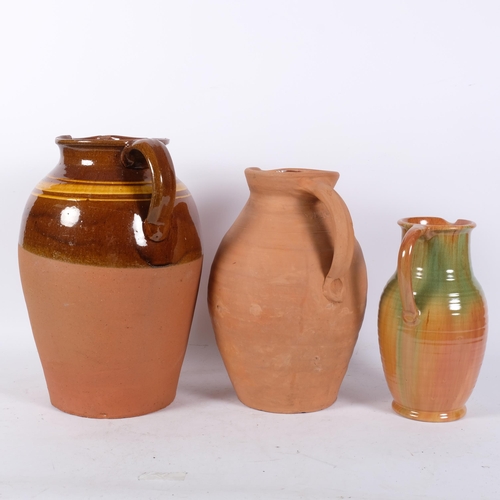 1032 - A half glazed Buckley terracotta jug, H36cm, and 2 smaller jugs