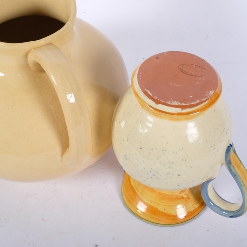 1044 - A cream glazed French ceramic jug, H25cm, and a smaller jug with painted decoration