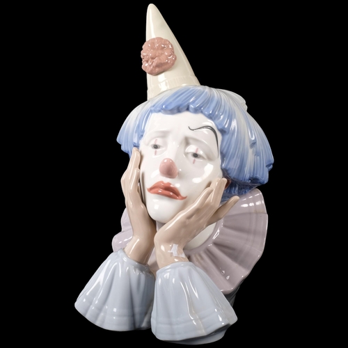 797 - A ceramic Lladro clown face resting on hands, sad facial expression, H31cm