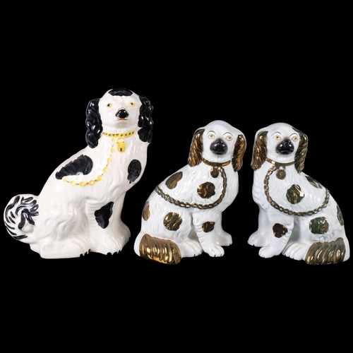 801 - A pair of Staffordshire Spaniels, H23cm, and a third left-facing Staffordshire Spaniel ceramic figur... 