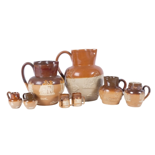 919 - A group of Harvest jugs, tallest 16cm, including miniature Doulton jugs and tyg, some restoration an... 