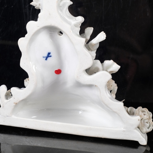 928 - A German porcelain wall bracket, with applied flowers and cherub (some petals chipped), H21cm