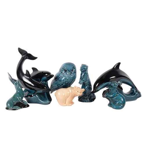 932 - A group of 2 Poole Pottery dolphins, H24cm, Poole owl, seal, otter, etc