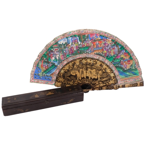 177 - A Chinese Mandarin fan, having a double-sided polychrome leaf painted with figures in buildings and ... 