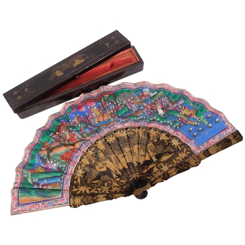 177 - A Chinese Mandarin fan, having a double-sided polychrome leaf painted with figures in buildings and ... 