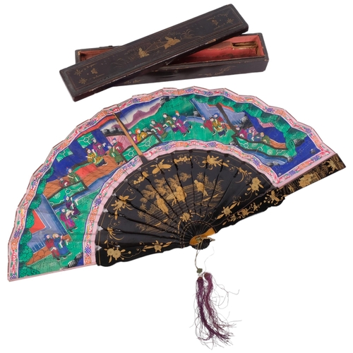 178 - A Chinese Mandarin fan, having a double-sided polychrome leaf painted with figures in buildings and ... 