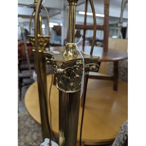 2575 - Two similar brass Corinthian column standard lamps. Tallest height to bayonet 142cm.