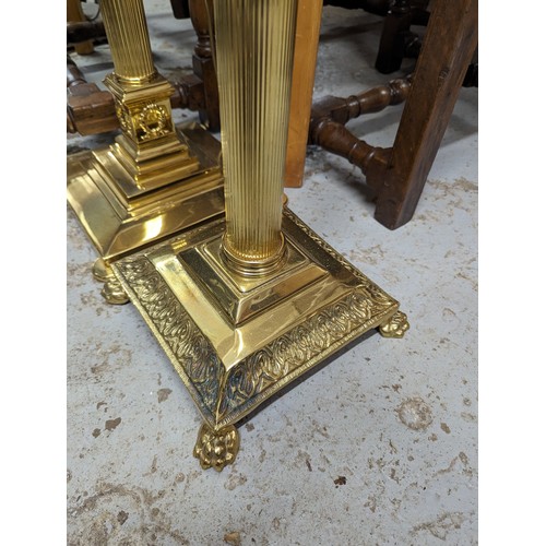 2575 - Two similar brass Corinthian column standard lamps. Tallest height to bayonet 142cm.