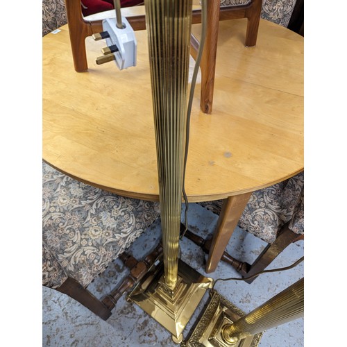 2575 - Two similar brass Corinthian column standard lamps. Tallest height to bayonet 142cm.