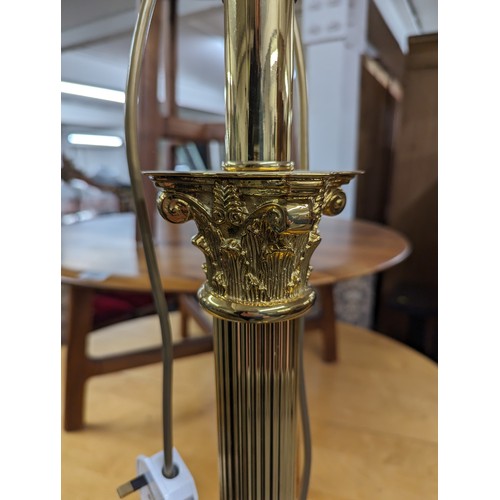 2575 - Two similar brass Corinthian column standard lamps. Tallest height to bayonet 142cm.