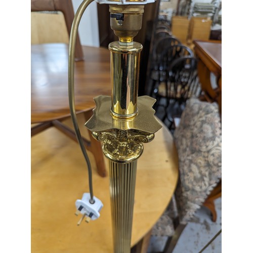 2575 - Two similar brass Corinthian column standard lamps. Tallest height to bayonet 142cm.