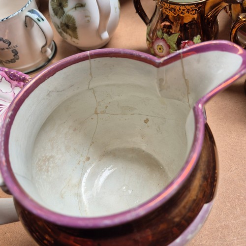 840 - A group of Sunderland lustre and lustre ware ceramic jugs, various sizes and motifs, largest height ... 