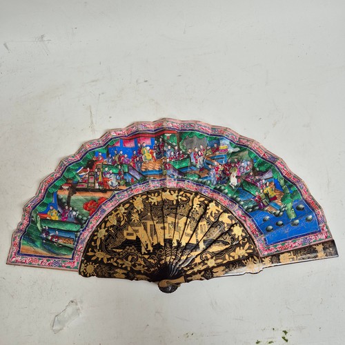 177 - A Chinese Mandarin fan, having a double-sided polychrome leaf painted with figures in buildings and ... 