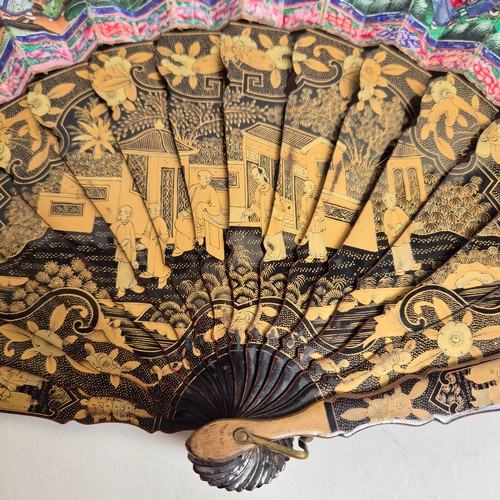 177 - A Chinese Mandarin fan, having a double-sided polychrome leaf painted with figures in buildings and ... 