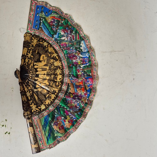 177 - A Chinese Mandarin fan, having a double-sided polychrome leaf painted with figures in buildings and ... 