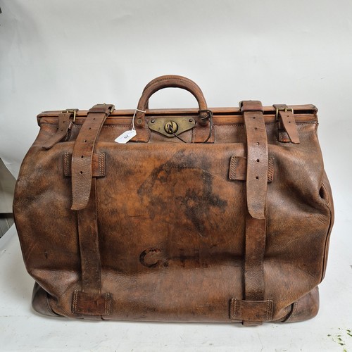 92 - A large Antique leather Gladstone travel bag, with hinged folding sides and leather straps, by John ... 