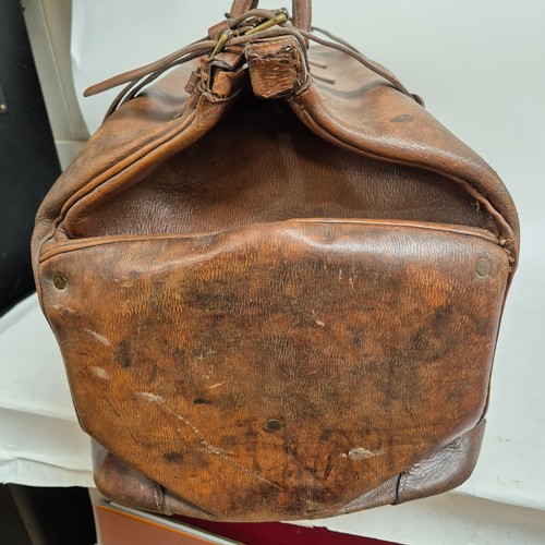 92 - A large Antique leather Gladstone travel bag, with hinged folding sides and leather straps, by John ... 