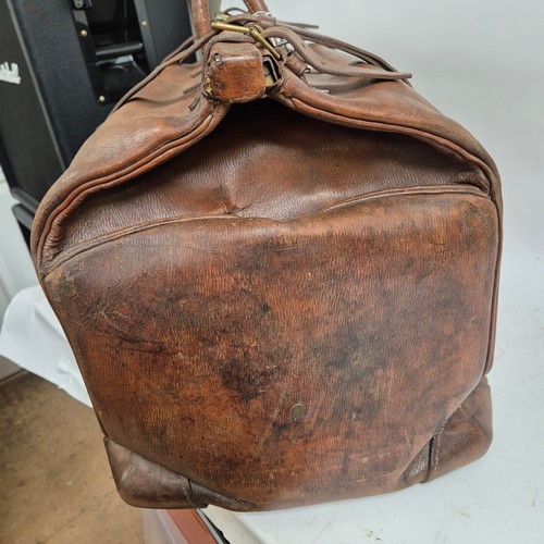 92 - A large Antique leather Gladstone travel bag, with hinged folding sides and leather straps, by John ... 