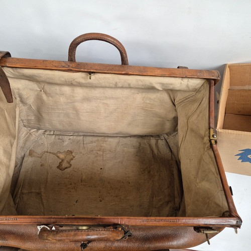 92 - A large Antique leather Gladstone travel bag, with hinged folding sides and leather straps, by John ... 