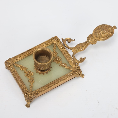 10 - A French ormolu and onyx chamber stick, circa 1900, with relief mask decorated handle, length 18.5cm