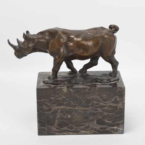 11 - Contemporary bronze rhino sculpture, on marble block base, indistinctly signed, rhino length 15.5cm,... 