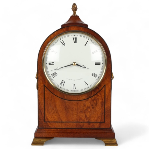 258 - A reproduction mahogany cased dome-top mantel clock, on brass bracket feet, by Comitti of London, he... 