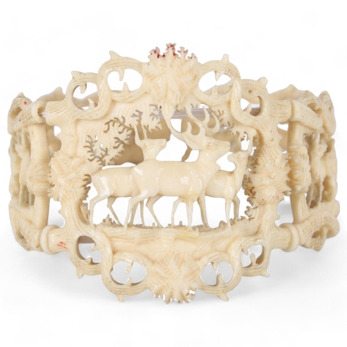 259 - A 19th century carved and pierced bone bracelet, depicting stags in woodland, central panel height 4... 