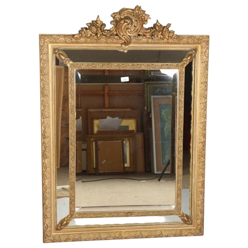 285 - A Venetian style gilt-gesso framed wall mirror, with bevel panels, dimensions excluding pediment 107... 