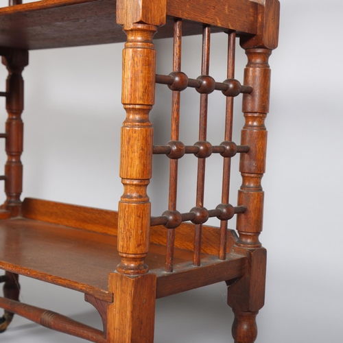 53 - Leonard Wyburd for Liberty & Co, oak 3-tier library table, with bobbin spindle side panels, and supp... 