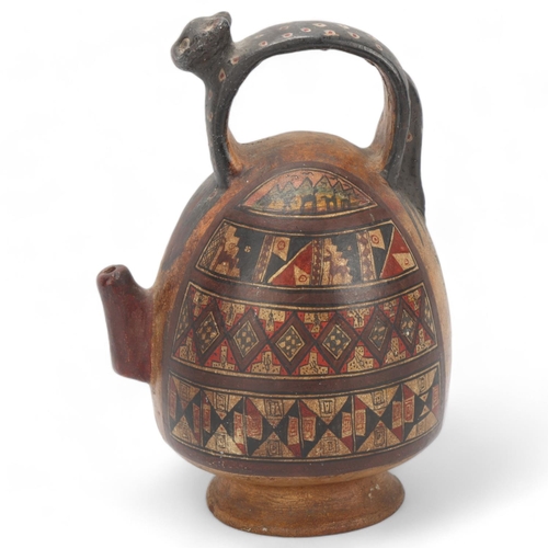 70 - A 16th century Peruvian terracotta ceremonial chicha pot, with puma handle and geometric painted pan... 