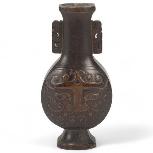 73 - A miniature Chinese patinated bronze vase, with relief cast decoration, height 10cm