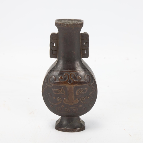 73 - A miniature Chinese patinated bronze vase, with relief cast decoration, height 10cm