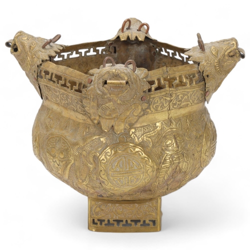 74 - A brass hanging censer, Chinese or Tibetan, with dog of fo suspension mounts and embossed decoration... 