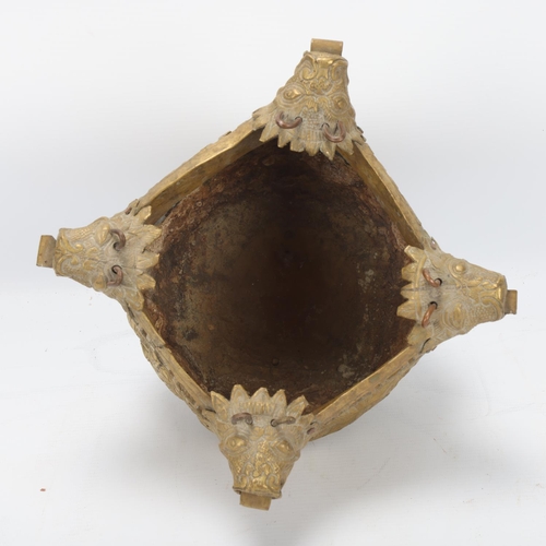 74 - A brass hanging censer, Chinese or Tibetan, with dog of fo suspension mounts and embossed decoration... 