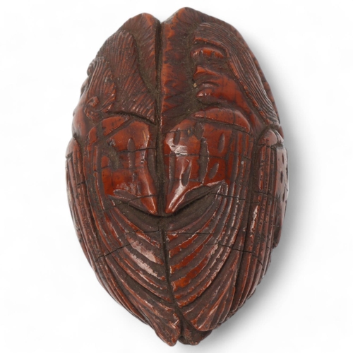 80 - 19th century coquilla nut, relief carved all round with portraits of men, length 6.5cm