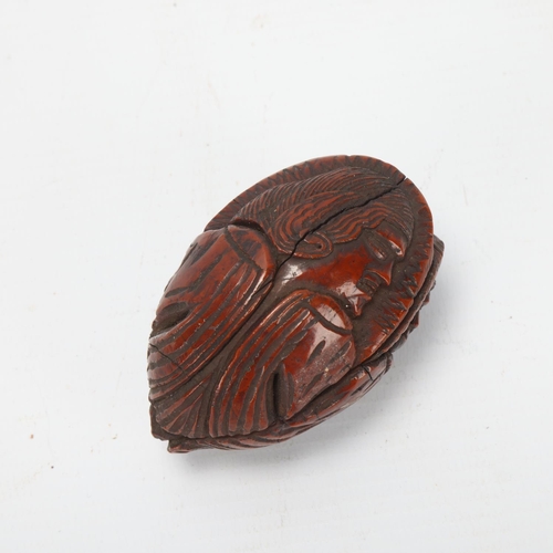 80 - 19th century coquilla nut, relief carved all round with portraits of men, length 6.5cm