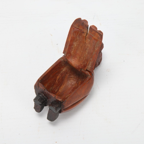 82 - 19th century coquilla nut box in the form of a figure, height 9cm