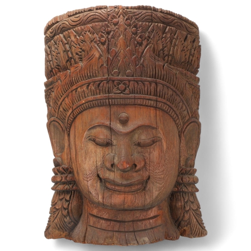 92 - A large Burmese relief carved wood mask wall carving, height 57cm