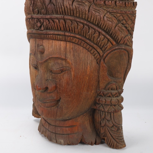 92 - A large Burmese relief carved wood mask wall carving, height 57cm