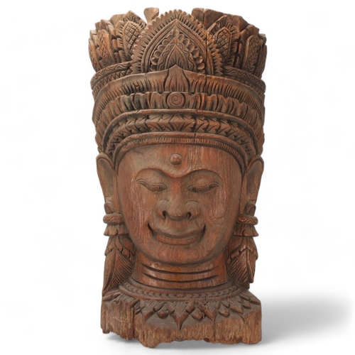 93 - A large Burmese relief carved wood mask wall carving, height 67cm